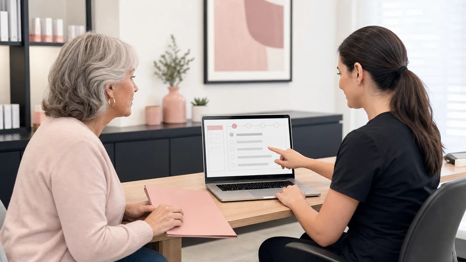 Medical provider guiding an adult client through an abstract online application process.