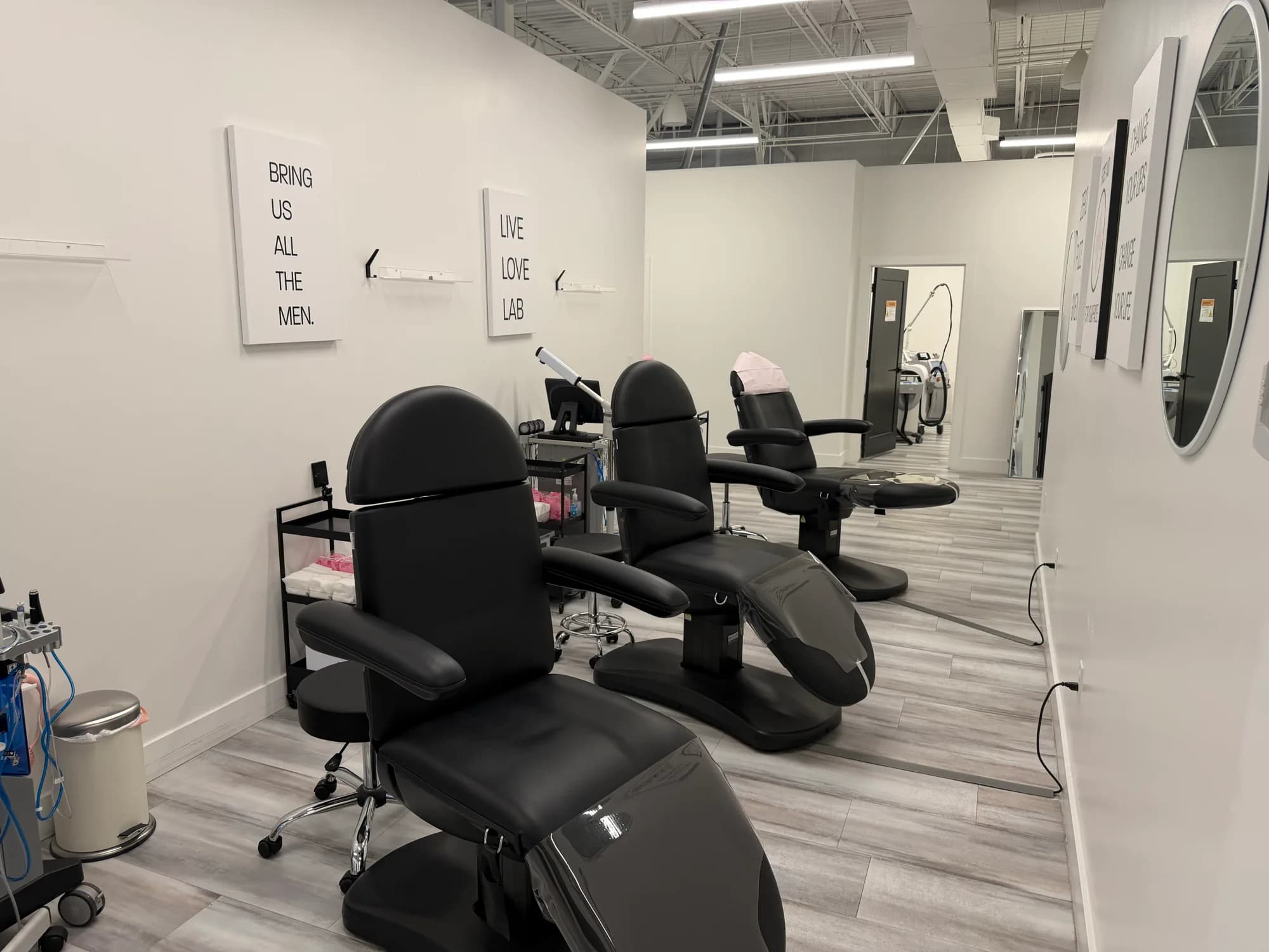 Injectable treatment room with black treatment chairs at Beauty Lab + Laser in Murray, Utah.