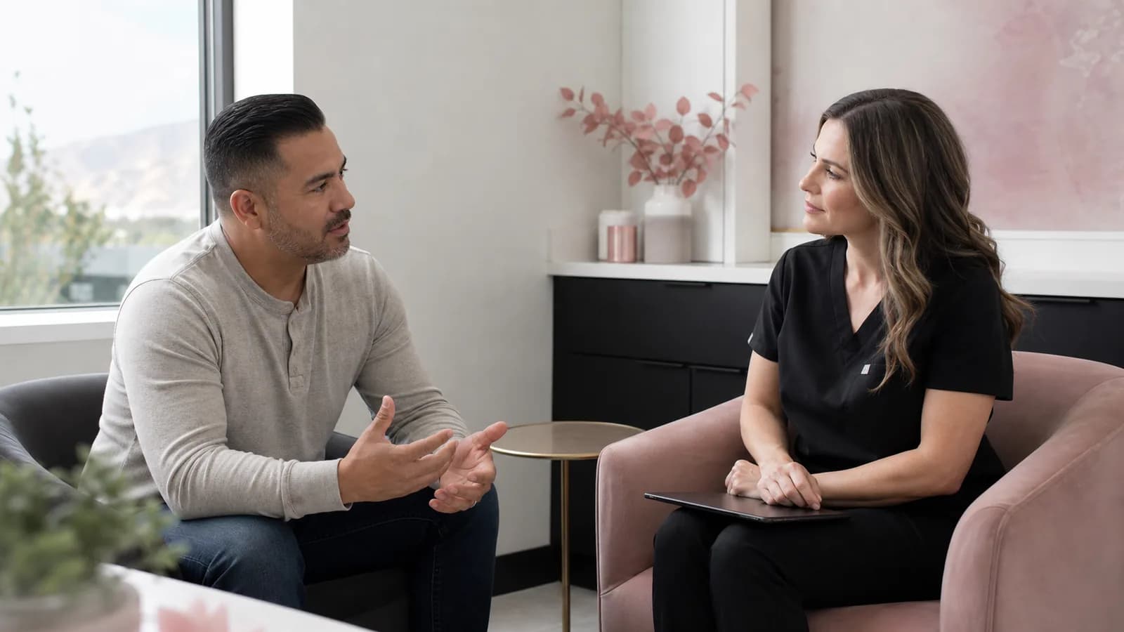 Adult male client having a private wellness consultation with a medical provider.