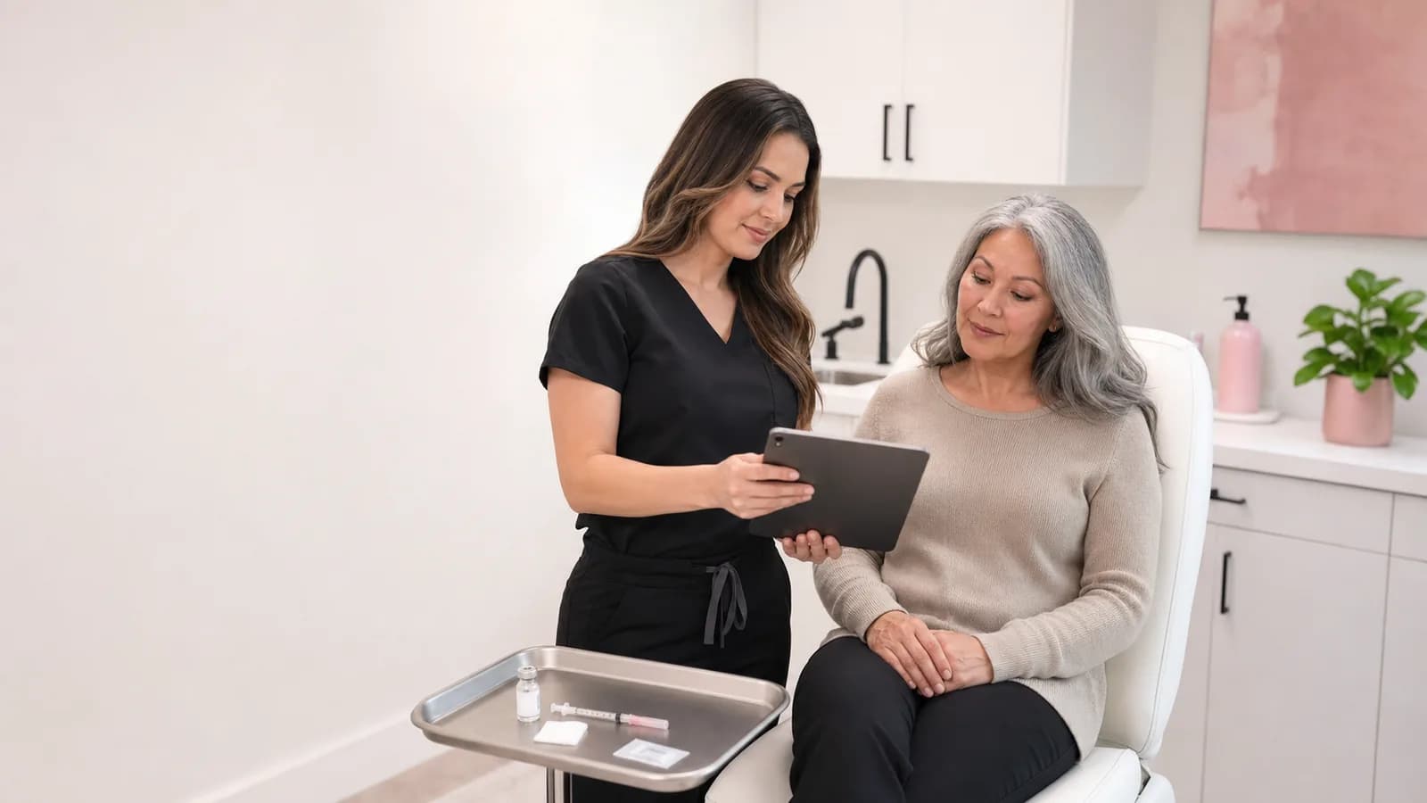Medical provider reviewing a wellness-shot appointment with an adult client.