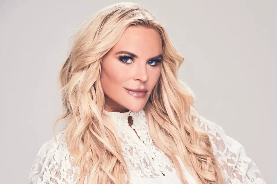 Heather Gay in a white lace blouse.
